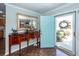 Stylish entryway with a decorative table, mirror, and a pop of color from the light blue door at 1233 Bridgeport Dr, Mount Pleasant, SC 29466