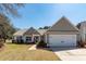 Charming one-story home with a two-car garage, landscaped front yard, and inviting curb appeal at 1233 Bridgeport Dr, Mount Pleasant, SC 29466