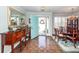 Elegant foyer featuring hardwood floors, dining area with a chandelier, and a brightly colored front door at 1233 Bridgeport Dr, Mount Pleasant, SC 29466