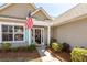 Inviting front entrance with American flag, wreath, and well-manicured landscaping, enhancing curb appeal at 1233 Bridgeport Dr, Mount Pleasant, SC 29466