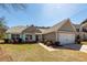 Charming single-story home with a well-manicured front yard and attached two-car garage at 1233 Bridgeport Dr, Mount Pleasant, SC 29466