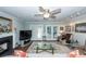 Comfortable living room with a fireplace, ceiling fan, glass coffee table, and access to the backyard at 1233 Bridgeport Dr, Mount Pleasant, SC 29466