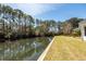 Picturesque pond behind the home, lined with mature trees for privacy and beauty at 1233 Bridgeport Dr, Mount Pleasant, SC 29466