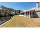 Screened porch and backyard view with tranquil pond access, perfect for relaxing outdoors at 1233 Bridgeport Dr, Mount Pleasant, SC 29466