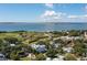Beautiful aerial view of a coastal town with waterfront access, historic sites, and lush greenery under a partly cloudy sky at 1302 Middle St, Sullivans Island, SC 29482