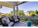 Cozy balcony with wicker chairs, decorative pillows, and a calming neighborhood view at 1302 Middle St, Sullivans Island, SC 29482
