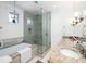Spa bathroom features granite double vanity, soaking tub, and tiled walk in shower at 1302 Middle St, Sullivans Island, SC 29482