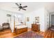 Bright bedroom featuring a four-poster bed, hardwood floors, and stylish furnishings, creating a serene and inviting space at 1302 Middle St, Sullivans Island, SC 29482