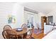 Charming dining area with wood table, chairs, and a view of the balcony at 1302 Middle St, Sullivans Island, SC 29482