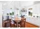 Bright kitchen boasts white cabinets, stainless appliances, wood island countertop and wooden floors at 1302 Middle St, Sullivans Island, SC 29482