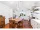 Bright kitchen features stainless appliances, white cabinets, wood island countertop and hardwood floors at 1302 Middle St, Sullivans Island, SC 29482