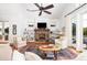 Bright living room with a brick fireplace, built-in shelves, and stylish furniture at 1302 Middle St, Sullivans Island, SC 29482