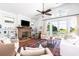Cozy living room with a brick fireplace, shiplap walls, and ample natural light at 1302 Middle St, Sullivans Island, SC 29482