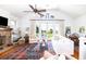 Inviting living room features hardwood floors, a brick fireplace, and an abundance of natural light at 1302 Middle St, Sullivans Island, SC 29482