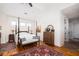 Spacious main bedroom features a four-poster bed, hardwood floors, and natural light at 1302 Middle St, Sullivans Island, SC 29482