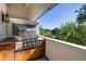 Modern outdoor kitchen with stainless steel grill, granite countertops, and wooden cabinets at 1302 Middle St, Sullivans Island, SC 29482