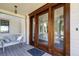 Inviting outdoor patio with wood-framed sliding doors and a cozy bench at 1302 Middle St, Sullivans Island, SC 29482
