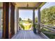 Charming porch view with stately columns, showcasing the neighborhood scenery at 1302 Middle St, Sullivans Island, SC 29482