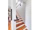 Bright staircase features hardwood treads, white risers, and ship-lap accent wall at 1302 Middle St, Sullivans Island, SC 29482