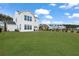 Large backyard with lush green lawn behind a modern two-story home at 1530 Homecoming Blvd, Ravenel, SC 29470