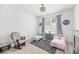 Bedroom with two toddler beds, a grey glider and a neutral rug at 1530 Homecoming Blvd, Ravenel, SC 29470