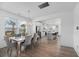 Elegant dining area with a modern chandelier, sleek table set, and open view to the kitchen at 1530 Homecoming Blvd, Ravenel, SC 29470