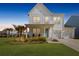 Charming two-story home features a manicured lawn, two-car garage, and a welcoming front porch at 1530 Homecoming Blvd, Ravenel, SC 29470