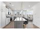 Modern kitchen featuring white cabinets, stainless appliances, large center island and pendant lighting at 1530 Homecoming Blvd, Ravenel, SC 29470