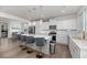Bright, open kitchen featuring a large island with seating, stainless steel appliances, and modern lighting at 1530 Homecoming Blvd, Ravenel, SC 29470