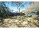 Backyard with mature trees, garden beds, and a privacy fence at 1637 Tatum St, Charleston, SC 29412