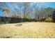 Large backyard featuring a fire pit with a tree-lined fence at 1637 Tatum St, Charleston, SC 29412