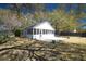 Large backyard with mature trees, a screened-in porch, and a patio at 1637 Tatum St, Charleston, SC 29412