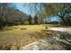 Spacious backyard featuring a fire pit and mature trees, perfect for outdoor enjoyment at 1637 Tatum St, Charleston, SC 29412