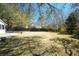 Spacious backyard with mature trees and a dark wood fence at 1637 Tatum St, Charleston, SC 29412