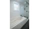 Modern bathroom featuring a walk-in shower, large soaking tub, and a window at 1637 Tatum St, Charleston, SC 29412