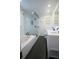A luxurious bathroom featuring a walk-in shower, large soaking tub, and a double vanity at 1637 Tatum St, Charleston, SC 29412
