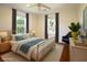 Bright bedroom featuring hardwood floors, a ceiling fan, and two windows with views of the surrounding greenery at 1637 Tatum St, Charleston, SC 29412