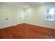 Bright bedroom features hardwood floors, large closet doors, and a window at 1637 Tatum St, Charleston, SC 29412