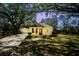Inviting exterior of home featuring mature trees, a well-maintained lawn, and a driveway leading to the attached garage at 1637 Tatum St, Charleston, SC 29412
