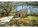 Charming home with a brick facade, inviting front porch, and a well-manicured lawn at 1637 Tatum St, Charleston, SC 29412
