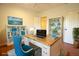 Bright home office featuring a wood desk, stylish blue chair, white bookcases, and a decorative coastal theme at 1637 Tatum St, Charleston, SC 29412