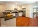 Well-lit kitchen featuring stainless steel appliances, granite countertops, white cabinets, and hardwood flooring at 1637 Tatum St, Charleston, SC 29412