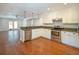 Bright kitchen featuring stainless steel appliances, granite countertops, white cabinets, and hardwood floors at 1637 Tatum St, Charleston, SC 29412