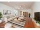 Bright living room with modern decor, hardwood floors, a ceiling fan, and neutral paint, creating a welcoming atmosphere at 1637 Tatum St, Charleston, SC 29412