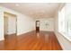 Spacious living room featuring hardwood floors, neutral walls, a ceiling fan, and a seamless connection to other rooms at 1637 Tatum St, Charleston, SC 29412