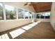 Bright sunroom with wood ceiling, wood floors and many windows with views to the back yard at 1637 Tatum St, Charleston, SC 29412