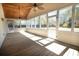 Bright sunroom with wood ceiling, wood floors and many windows with views to the back yard at 1637 Tatum St, Charleston, SC 29412