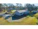 Aerial view showcasing a home with a wooden deck and ample parking space, bordered by lush landscaping and trees at 165 Infinity Dr, Dorchester, SC 29437