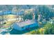 Aerial view capturing the cozy home with a wooden deck and the surrounding lush greenery, creating a serene atmosphere at 165 Infinity Dr, Dorchester, SC 29437