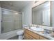 Bathroom with a shower-tub combo, a decorative mirror, and a marble-look vanity at 165 Infinity Dr, Dorchester, SC 29437